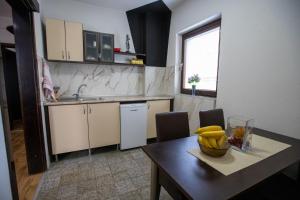 a kitchen with a table with a bowl of bananas on it at Pejik apartment in Ohrid