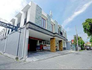 a white building with a sign on the side of it at Cahaya Green Bali in Pesanggaran