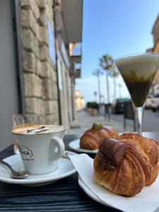 a table with two plates of pastries and a cup of coffee at B&B Casa CamiLory in San Lucido