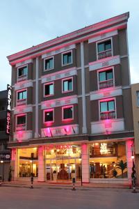 a building with pink lights on the front of it at Arya Hotel Sakarya in Sakarya