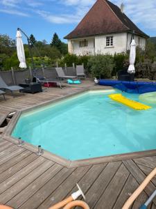 a large swimming pool on a wooden deck at gite de la croix in Saint-Léon-sur-Vézère