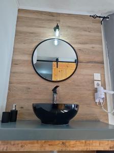 a bathroom with a black sink and a mirror at Maistrali in Provatas