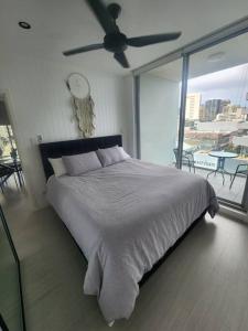 a bedroom with a large bed with a ceiling fan at Bondi Junction Beauty in Sydney