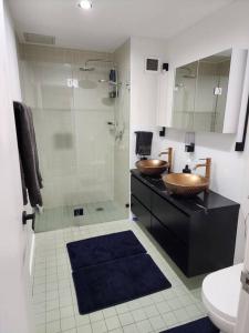 a bathroom with two sinks and a shower at Bondi Junction Beauty in Sydney