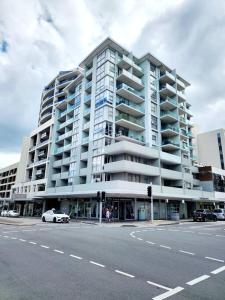 a large apartment building with a car parked in front of it at Bondi Junction Beauty in Sydney