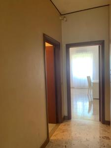 an empty room with a door leading to a window at Porta Napoli Rooms in Lecce +14 photos