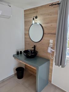 a bathroom with a black sink and a mirror at Maistrali in Provatas