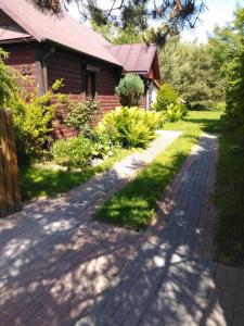 a driveway leading to a house at Noclegi przy kominku in Międzyleś