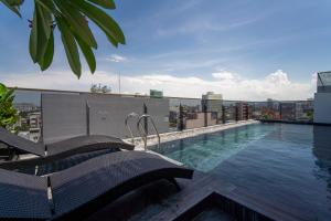 a swimming pool on the roof of a building at HSuites Riverside Hotel and Apartment in Da Nang