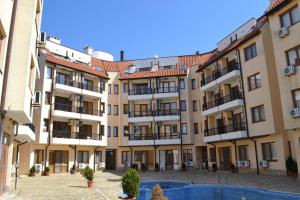 Bliznatsi的住宿－Апартамент в Oasis beach Kamchia - Най-любимото синьо，大型公寓楼,设有庭院