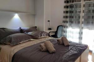 a bed with two pillows on it in a bedroom at L'HARMONIE, Appartement 2 chambres proche du lac, calme et lumineux in Annecy +11 photos