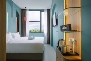 Postel nebo postele na pokoji v ubytování Wellesley Hotel