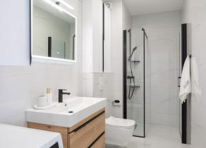 a bathroom with a sink and a toilet and a shower at A&D Deluxe apartments Dani with swimming pool in Promajna
