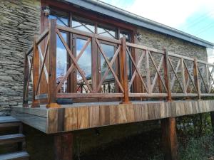 a wooden bridge in front of a building at La ferme de la Chapelle - Gîte et chambres d'hôtes in Cherain