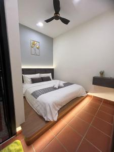 a bedroom with a bed with a ceiling fan at New! 1min to JonkerStreet Melaka loft 4BR 11 PAX in Melaka