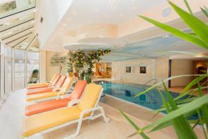 a room with a pool and a bunch of chairs at Berghof-Chalet in Erpfendorf