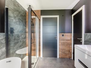 a bathroom with a shower and a toilet and a sink at The Black Barn in Marldon