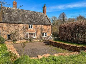 an old stone house with a driveway in front of it at Chipley Escapes - Otters Holt in Milverton