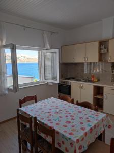 a kitchen with a table with a table cloth on it at Apartments Katica in Metajna