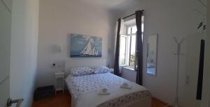 a small bedroom with a bed and a window at Studio Apartment NIKO II 5 min to center in Dubrovnik