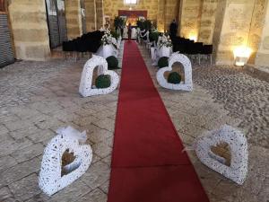 a red and white wedding aisle with a red and white at TOTI&MARY HOME in Partinico
