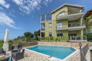 a villa with a swimming pool in front of a building at Villa Montenegrina in Petrovac na Moru +45 photos