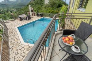 a bowl of fruit on a table next to a pool at Villa Montenegrina in Petrovac na Moru