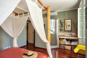 a bedroom with a canopy bed with a hat on it at Casa Marina in Bastia