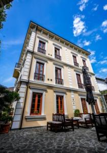 a large building with benches in front of it at Hotel Guri in Elbasan