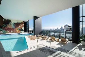 a pool on the roof of a building with a view at Luxury Casino Apartment in Broadbeach Island in Gold Coast