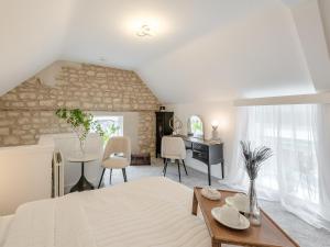 a bedroom with a bed and a table and a desk at Justaura Retreat in Branston