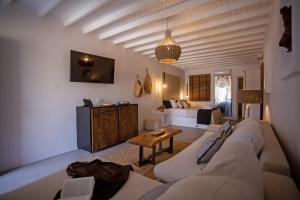 a living room with a couch and a table at Nur Mykonian Suites in Mikonos