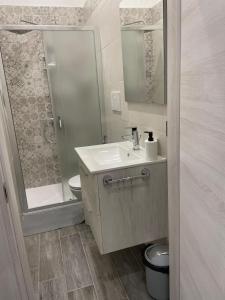 a bathroom with a sink and a shower and a toilet at B&B Poesia Affittacamere in Taranto
