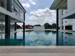a swimming pool in the middle of a building at Hygge Living Kampar (Near UTAR) in Kampar