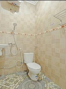 a bathroom with a shower and a toilet and a sink at Cahaya Green Bali in Pesanggaran