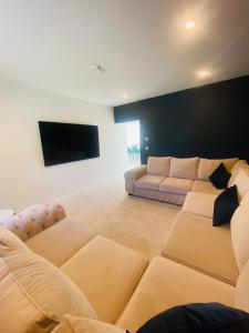 a living room with two couches and a flat screen tv at Farmhouse in Virginia County Cavan in Cavan