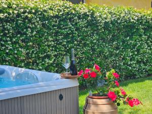 a bottle of wine and a glass next to a bathtub at La Rocca Maison de Charme in Moneglia