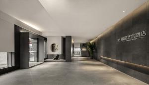 a hallway of a building with a sign on the wall at Guangzhou Shug Art Hotel in Guangzhou