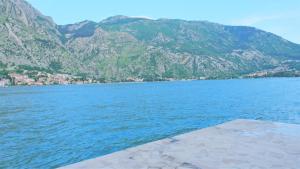 a large body of water with mountains in the background at Nature View Cozy Flat 1 min to Sea in Kotor in Tivat