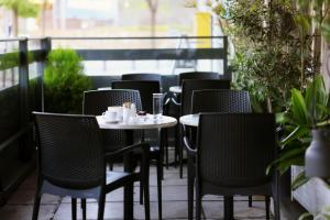 a row of chairs and tables on a patio at Abc Hotel in Thessaloniki +36 photos