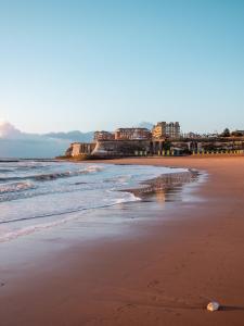 a view of the beach with buildings in the background at The Sea Lounge Accomodation in Broadstairs