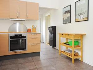 a kitchen with wooden cabinets and a counter top at 8 person holiday home in Ansager in Ansager