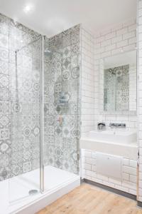 Lilleshall House & Gardens and Lilleshall National Sports Centre في تيلفورد: حمام مع دش وحوض استحمام ومغسلة