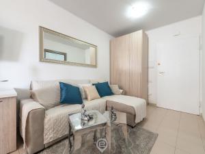 a living room with a couch and a mirror at Zaffiro Apartment in Quartu SantʼElena