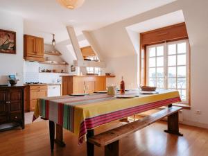 a kitchen with a table with a colorful table cloth on it at La Trinité/Mer, appt spacieux 4p, 100m², 3 ch, wifi, animaux admis - FR-1-477-79 in La Trinité-sur-Mer +6 photos