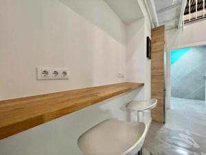 a white chair in a room with a counter at Apollo Project Coruña in A Coruña