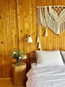 a bedroom with a bed and a table with flowers on it at House Girska Rika in Korchin +38 photos
