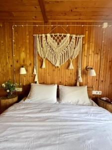 a bedroom with a white bed with wooden walls at House Girska Rika in Korchin