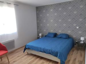 ein Schlafzimmer mit einem blauen Bett und einem roten Stuhl in der Unterkunft Gite terrasse sur Vercors in Saint-Marcellin + 14 Fotos