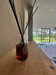 a vase with sticks in it sitting on a table at Rutzer Hotel Ristorante & Panoramic SPA in Asiago
